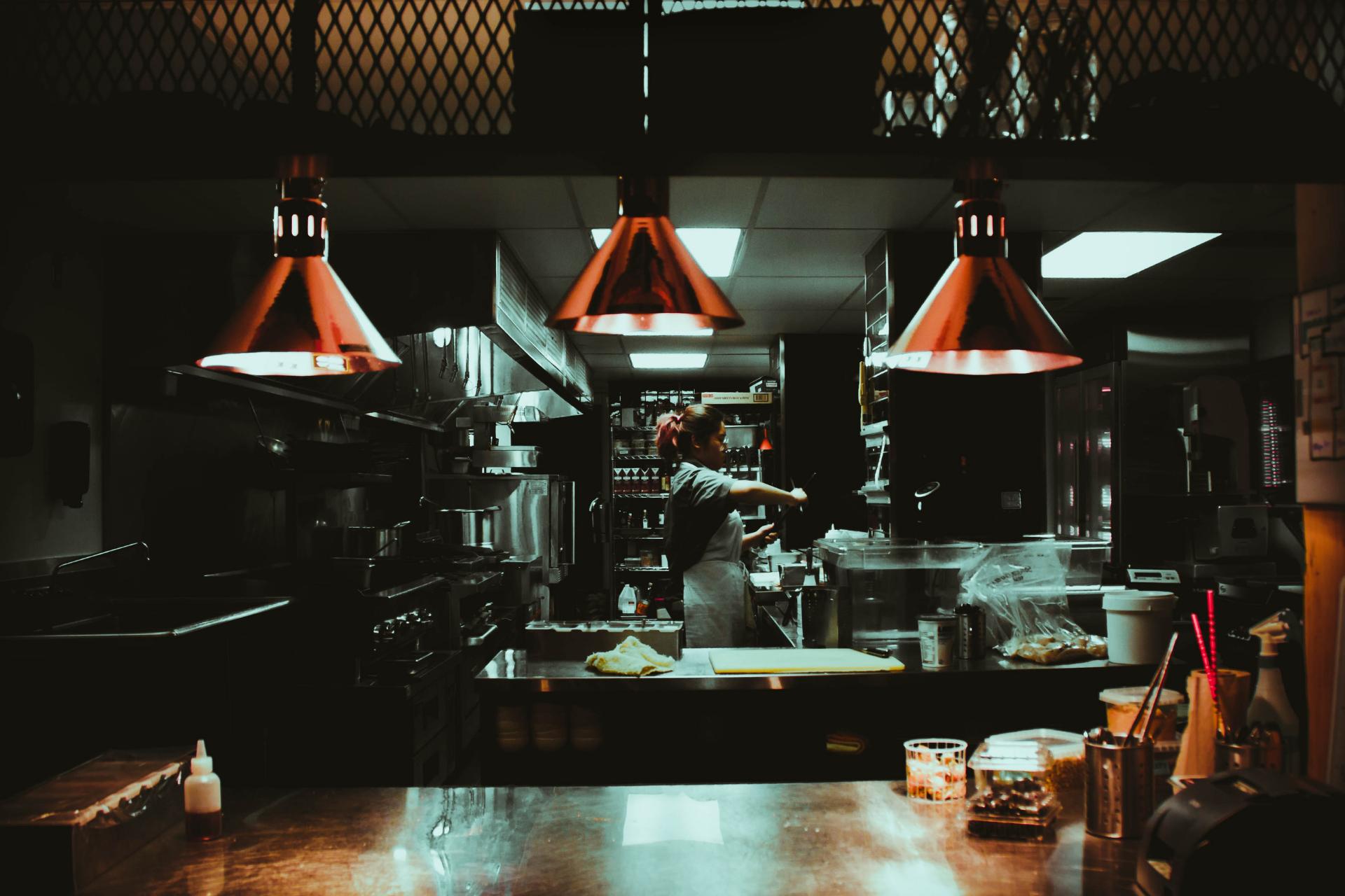 Cook working in an open restaurant kitchen