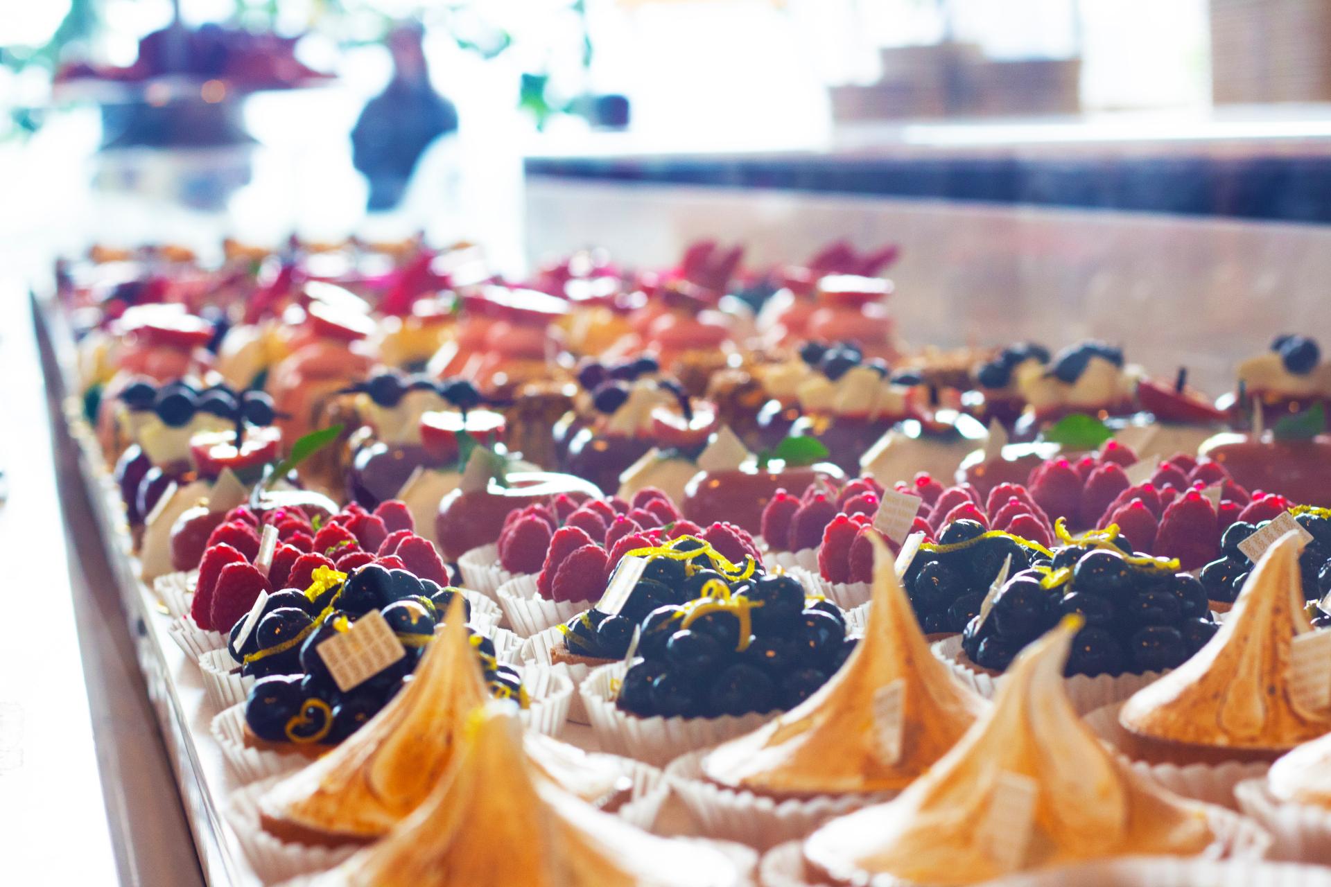 Lots of desserts lined up and ready to eat at a coffee shop