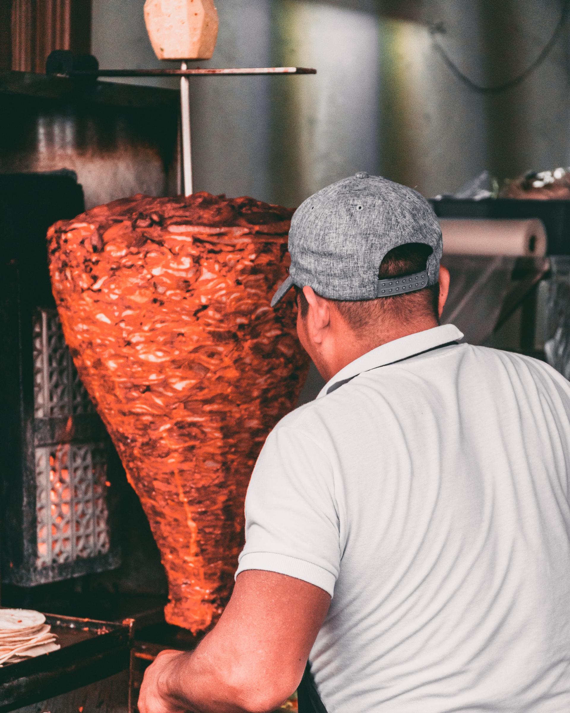 Guy making tacos at a restaurant in Mexico