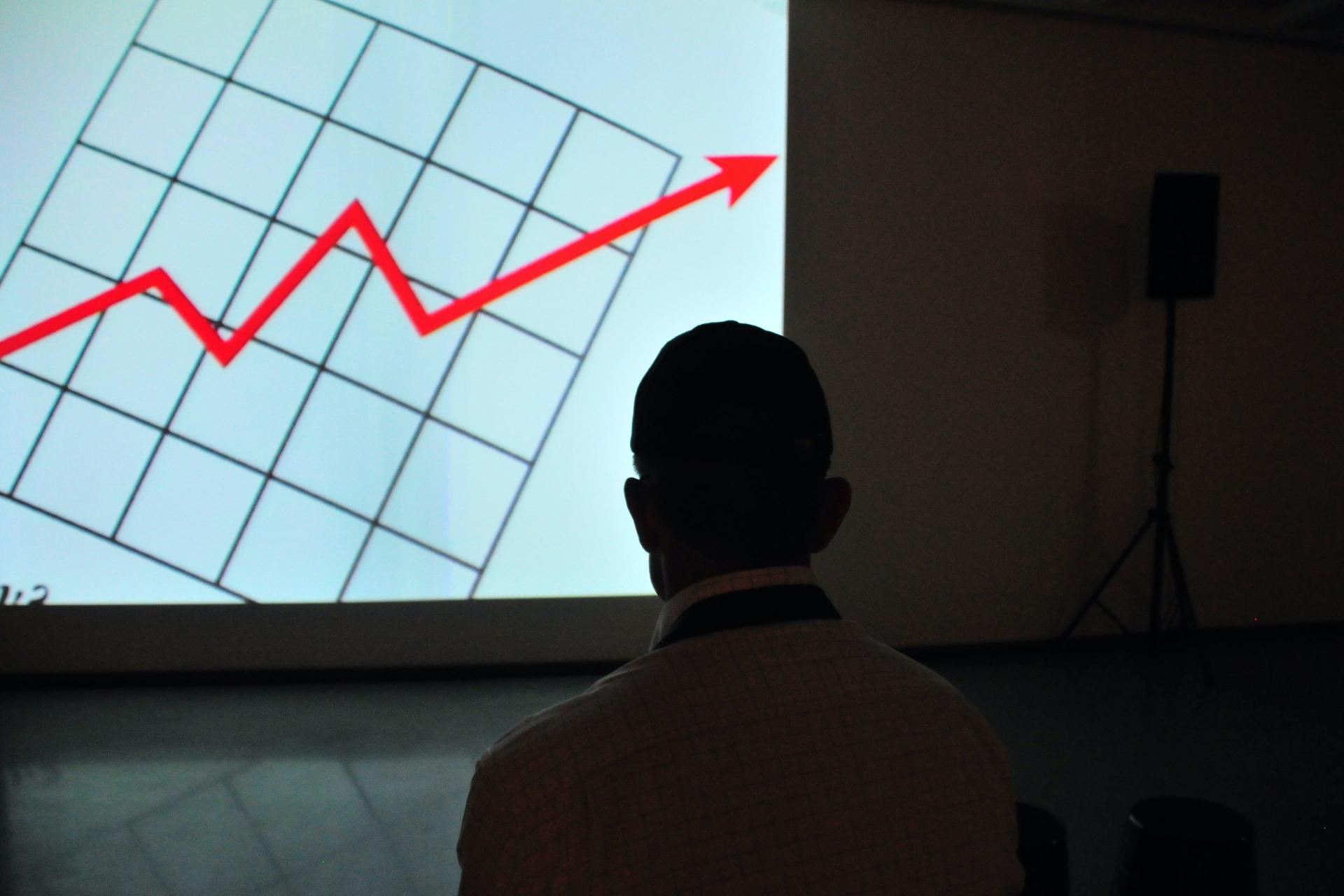 Guy watching profit increase presentation