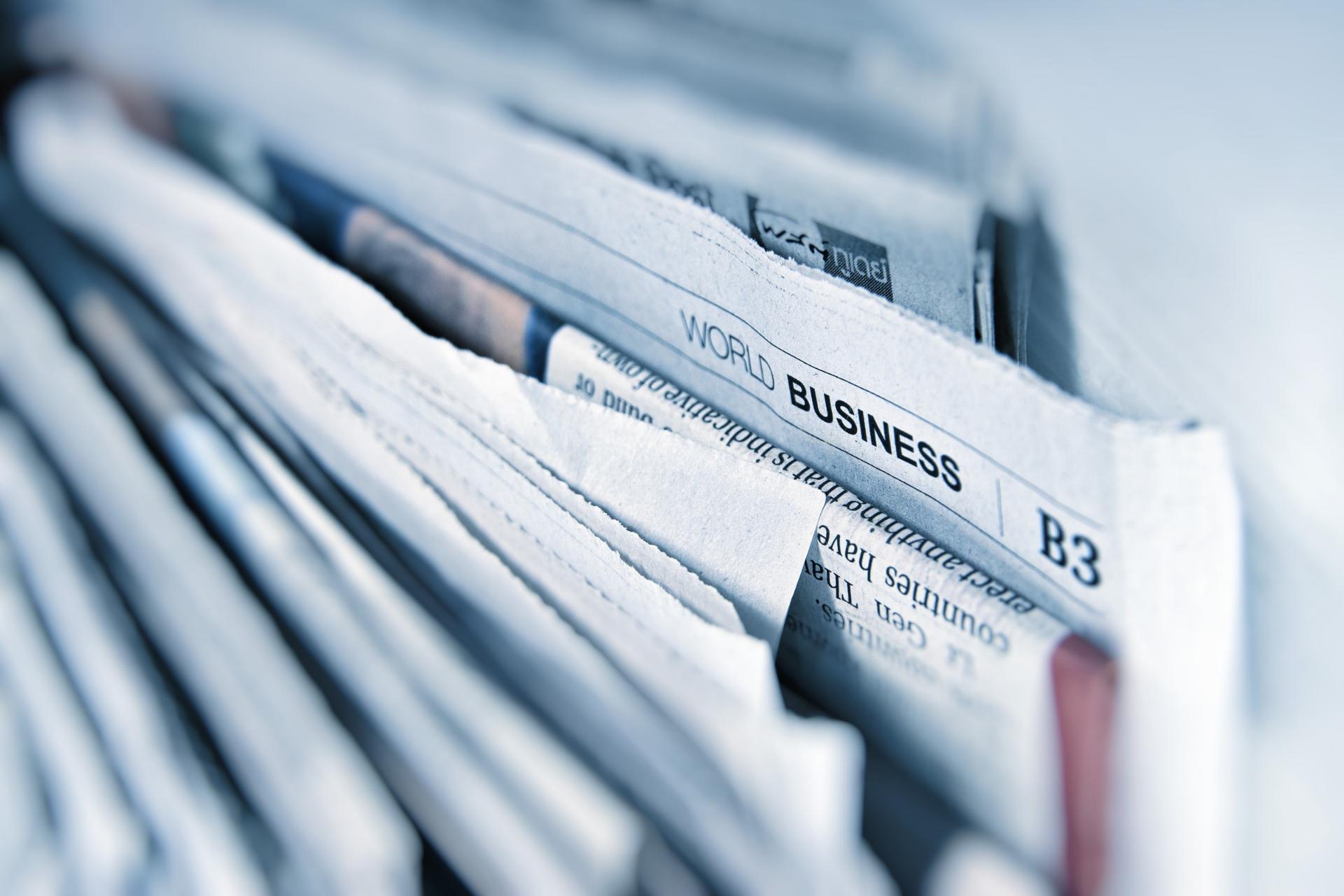 Folded newspaper highlighting world business section