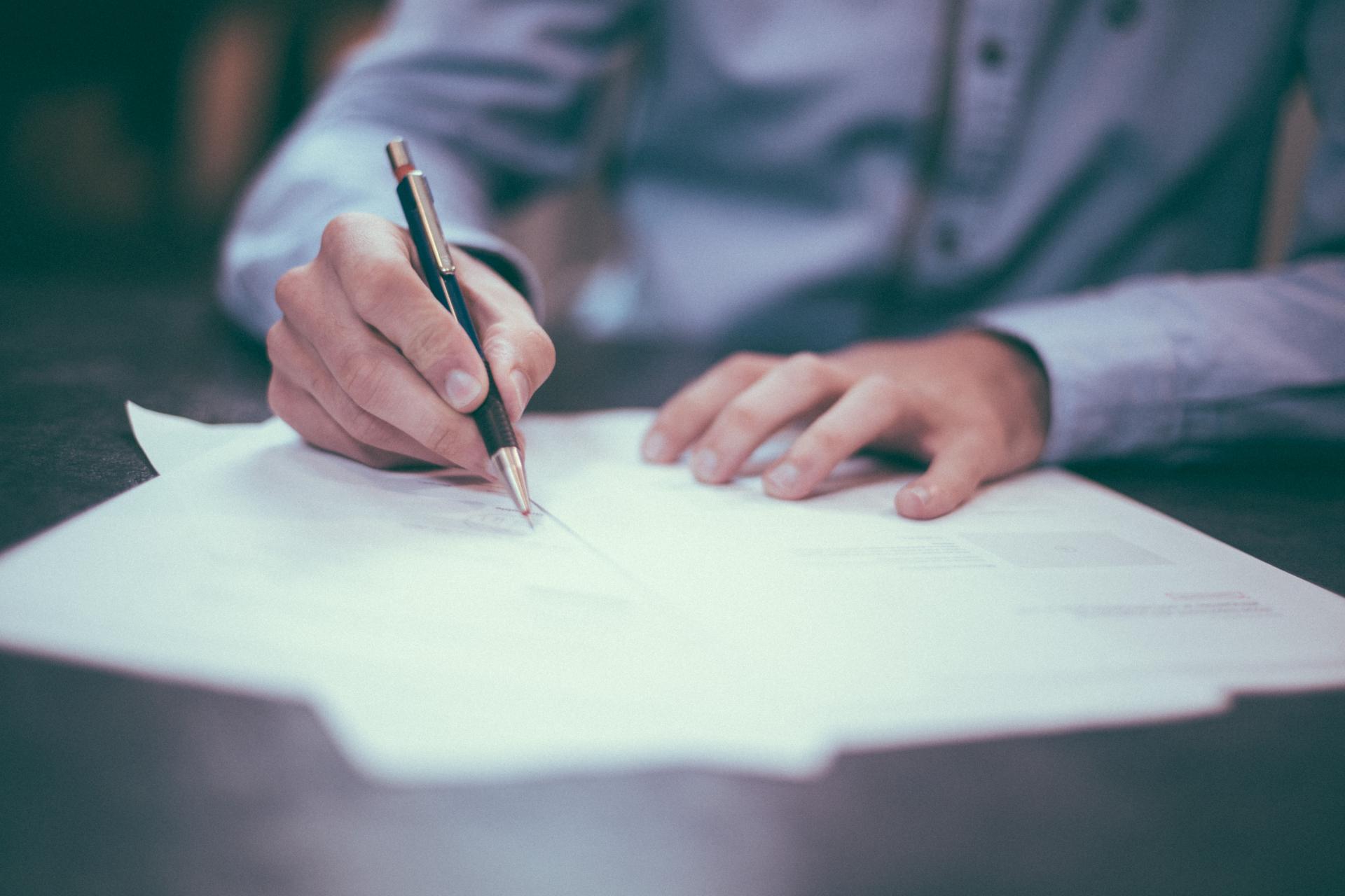 person signing paperwork