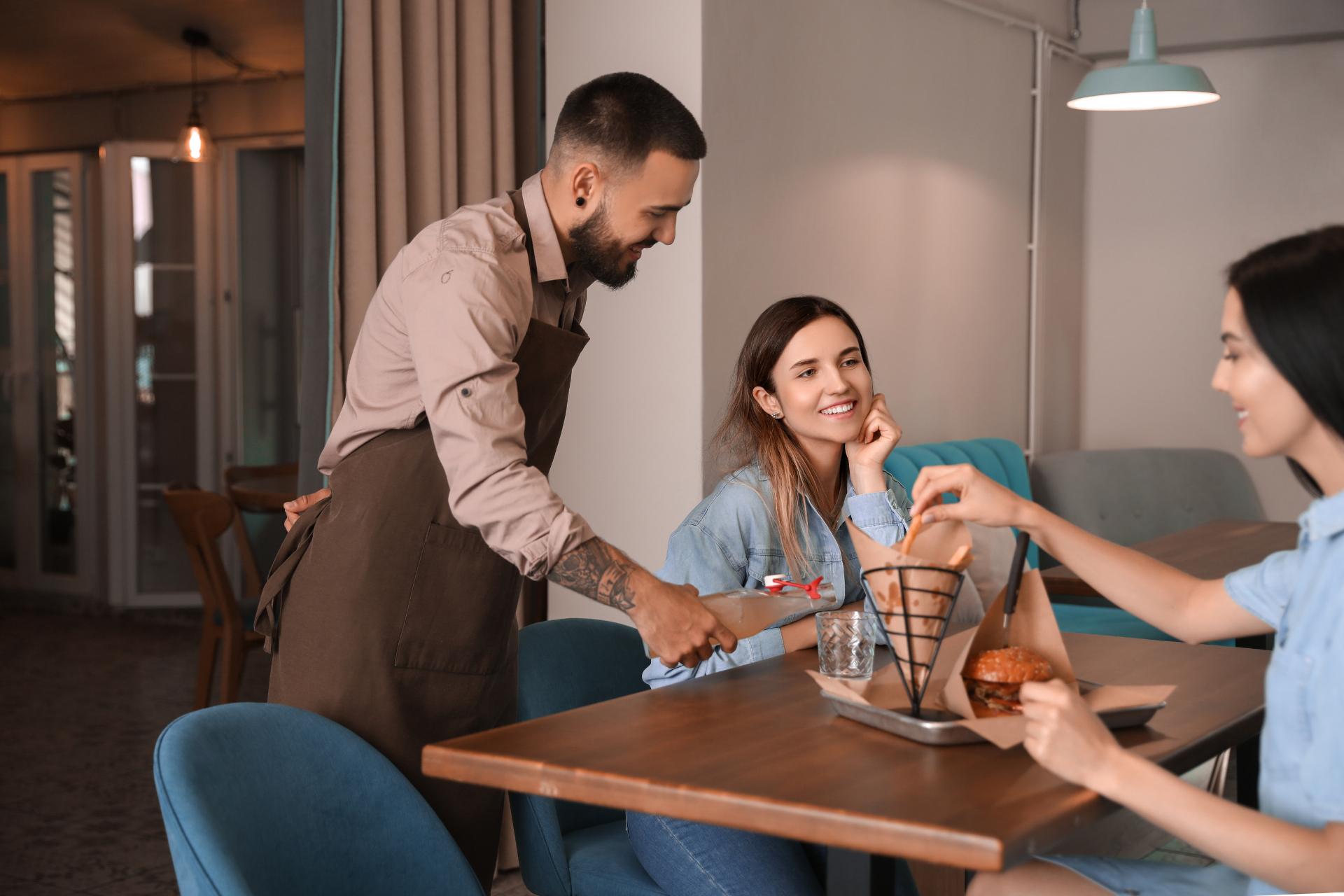 Restaurant clients receiving service from a waiter