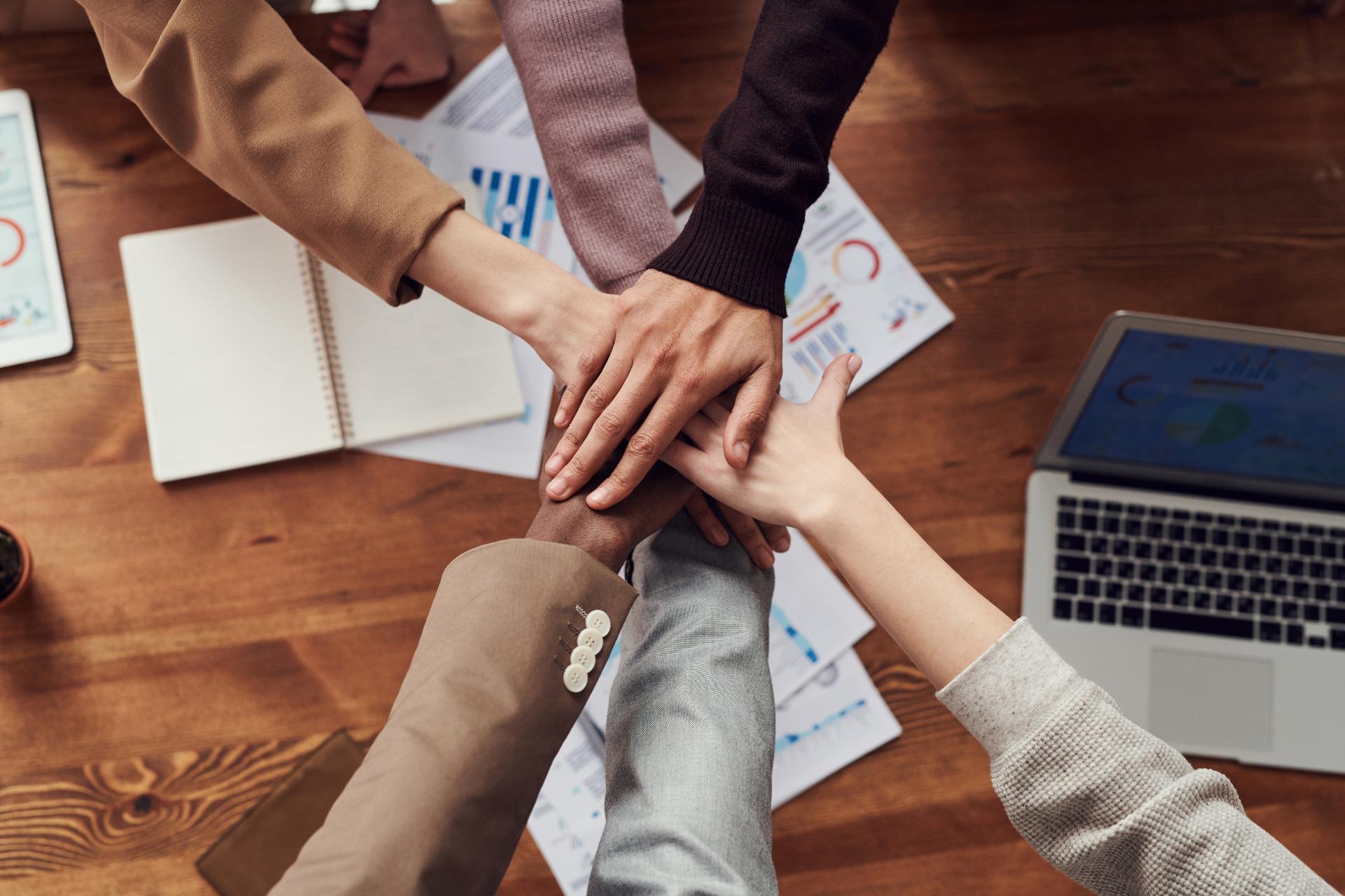 People gathering hands as a sign of teamwork