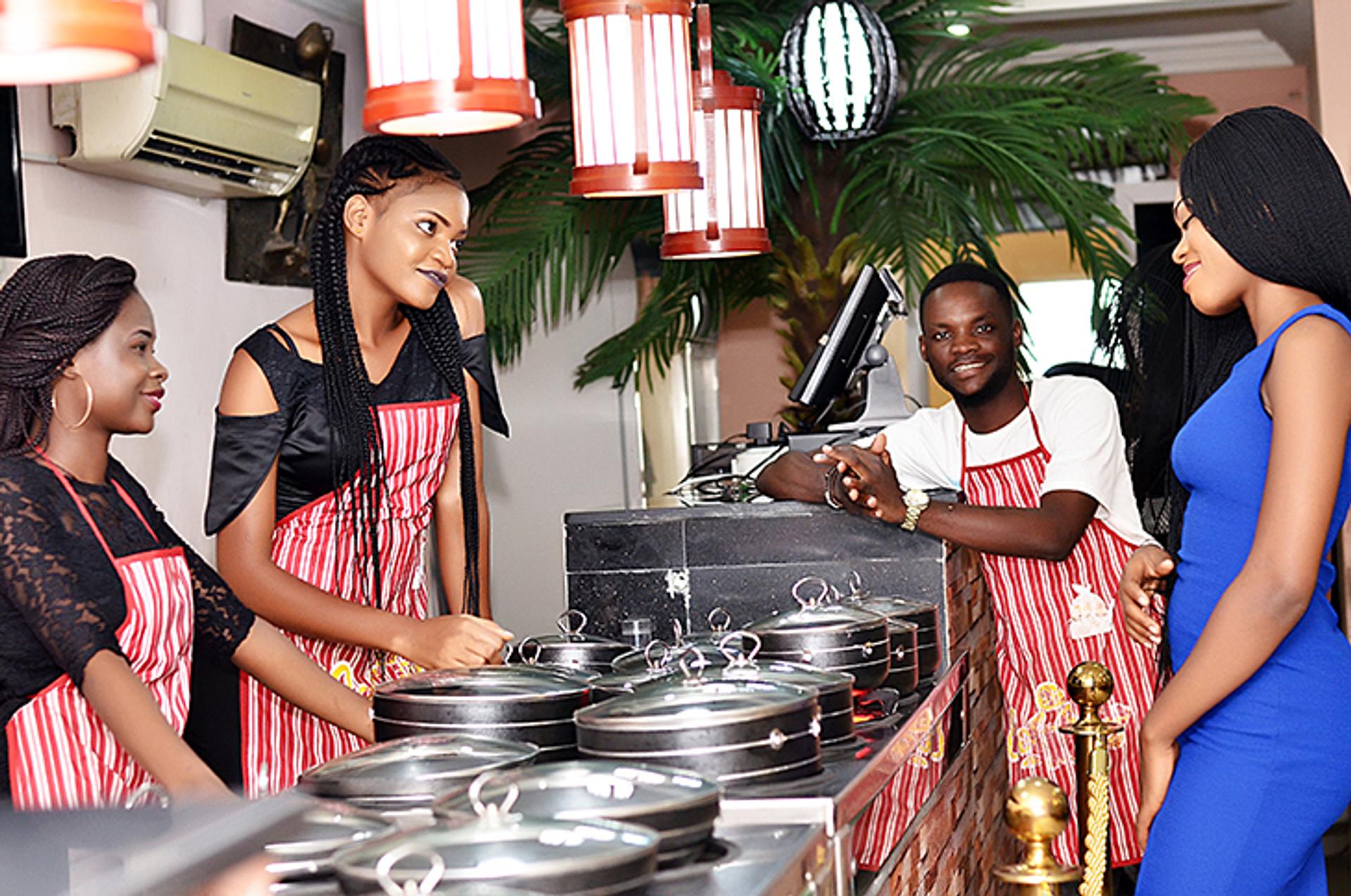 young waiters catering in aprons