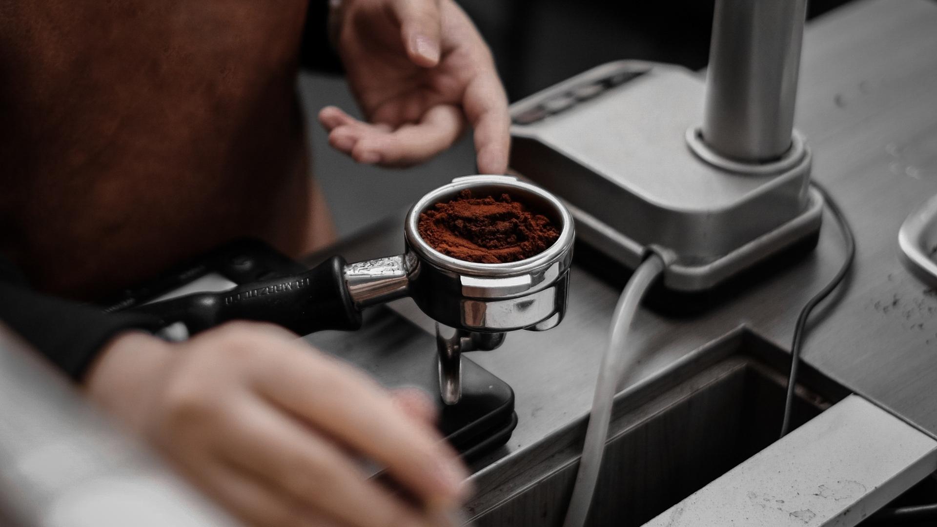 barista usando un portafiltro para preparar espresso