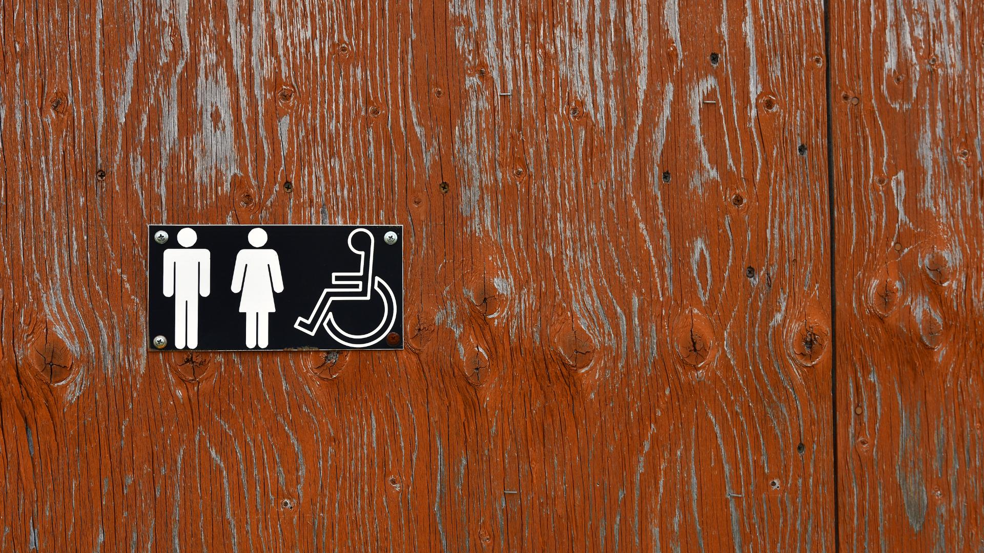 bathroom sign that discloses accessibility for people with limited mobility