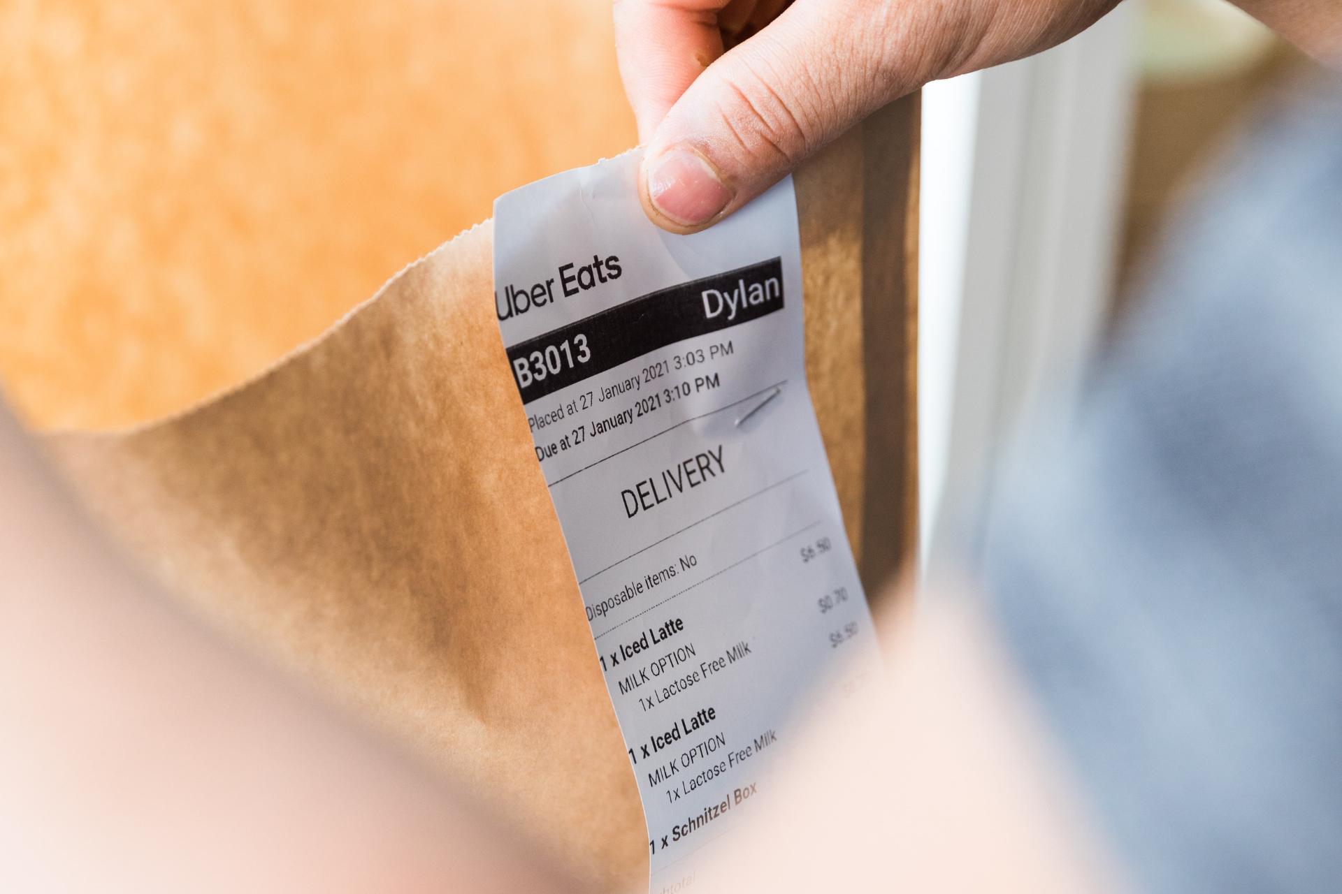  Restaurant customer checking a receipt he received with the order