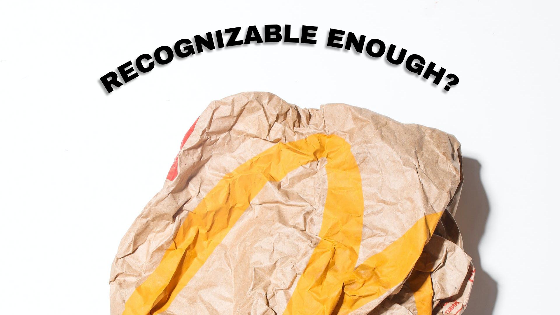 crumpled, yet recognizable mcdonald's paper bag with branding elements