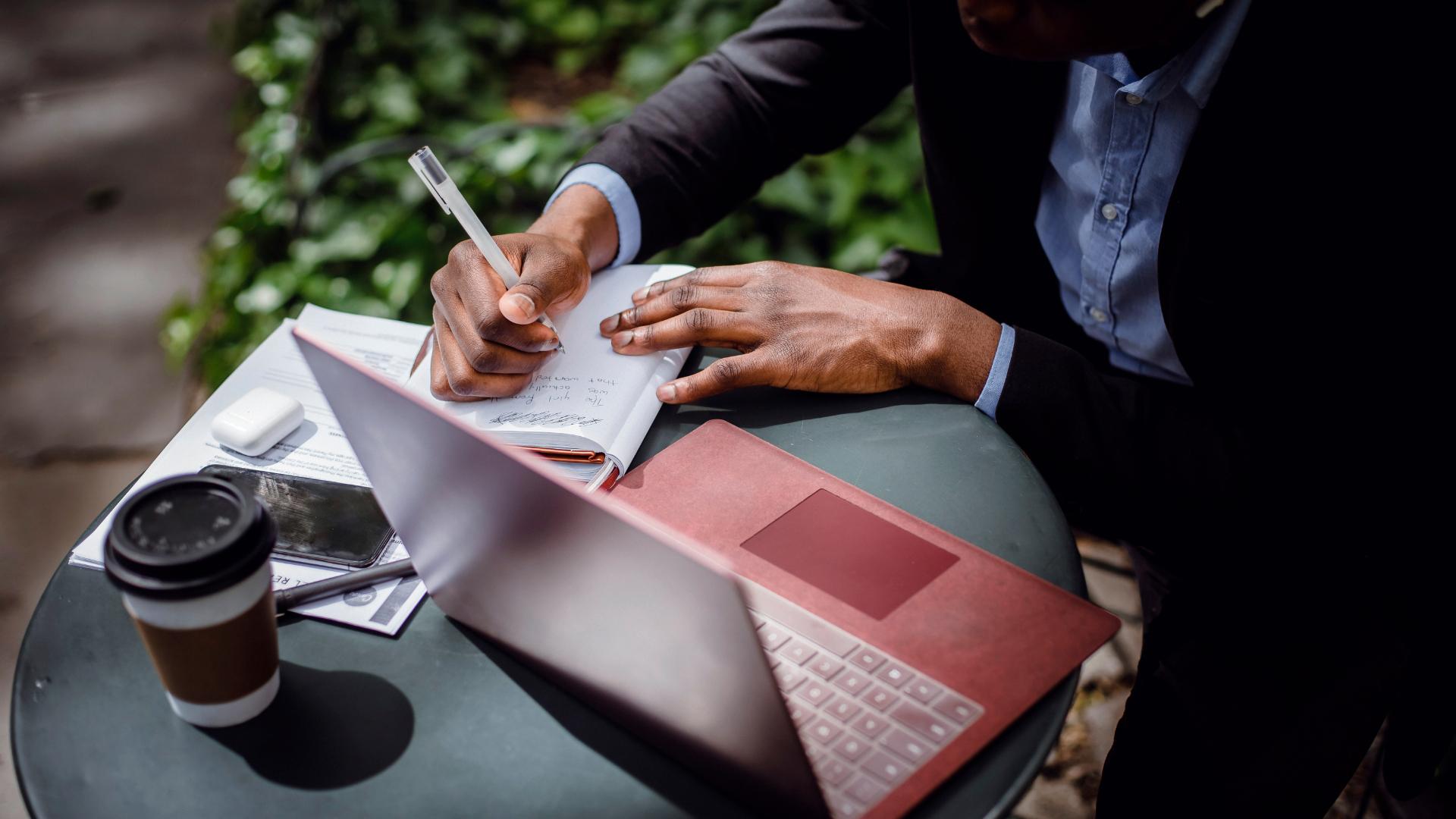 person taking notes for blog ideas