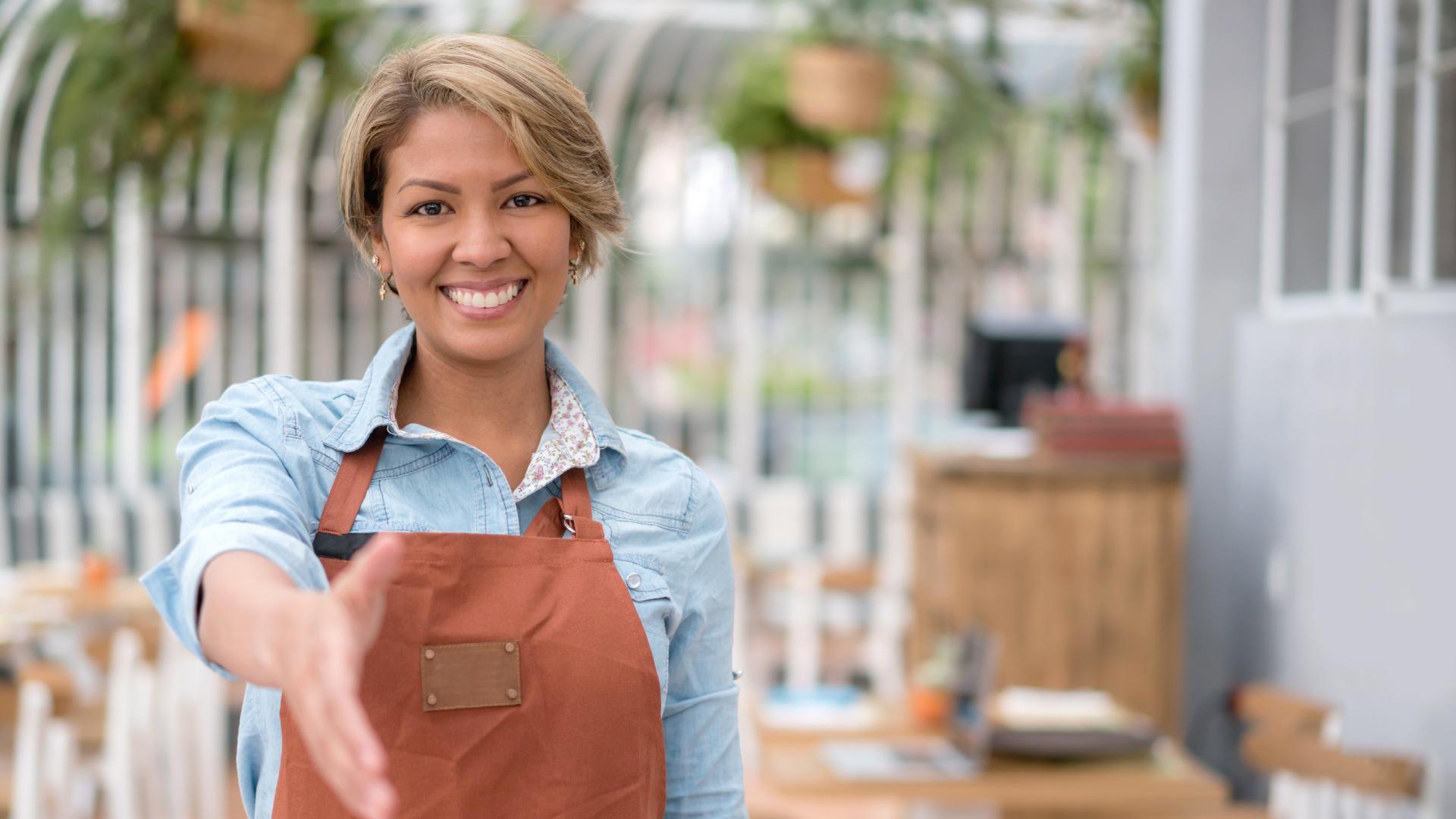 waitress offering a handshake to the customer